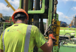 A worker operating a drill rig