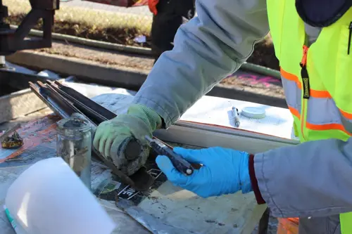 Cascade Environmental employee observing a split spoon sample