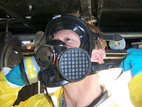 A worker wearing a full mask respirator