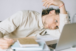 An overworked employee in front of his computer